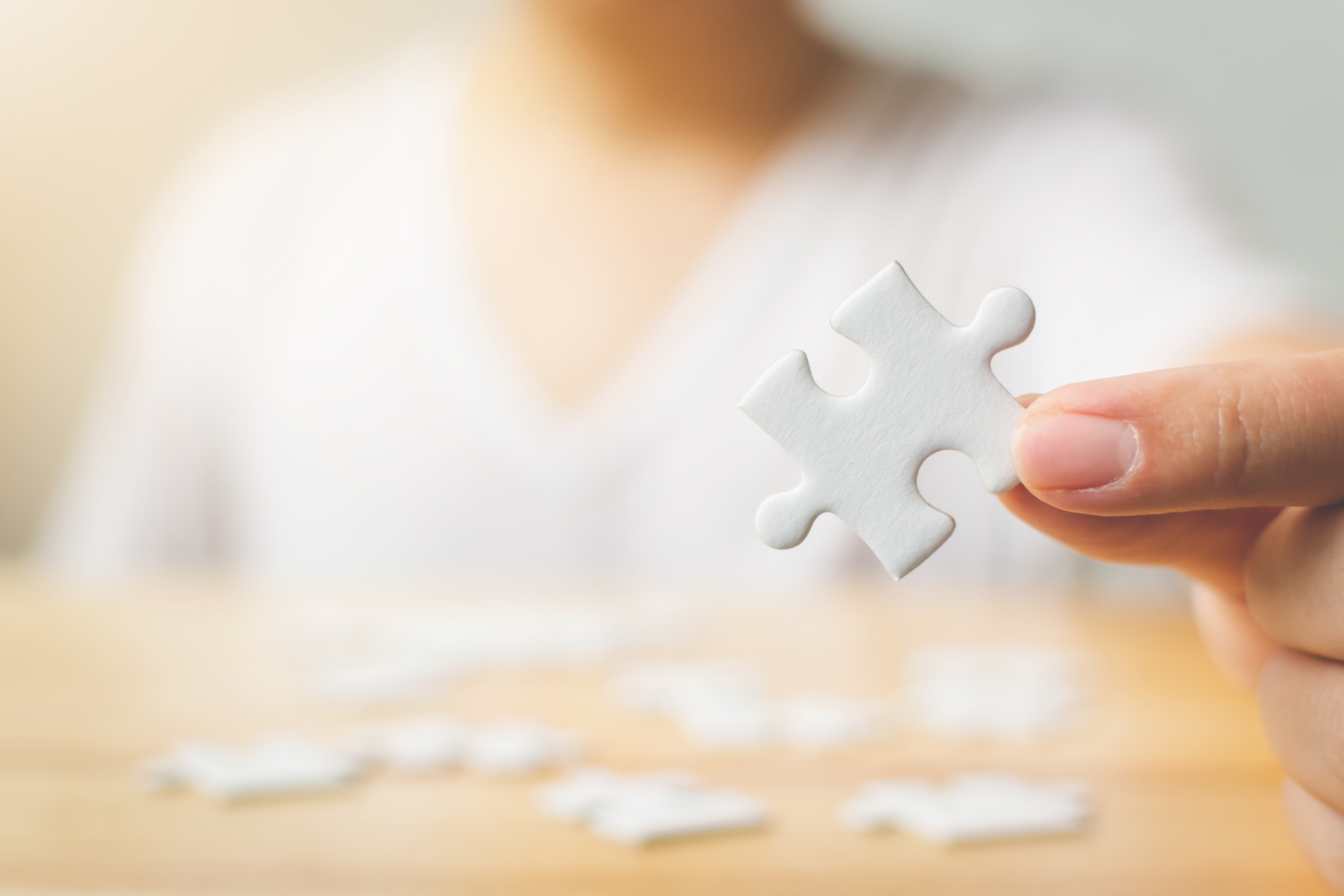 Hand,Of,Male,Trying,To,Connect,Pieces,Of,White,Puzzle